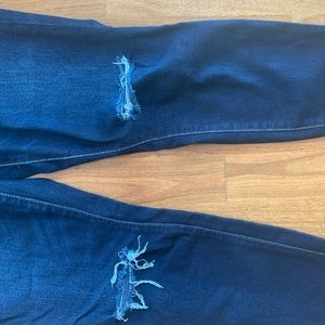 Distressed dark denim jeans